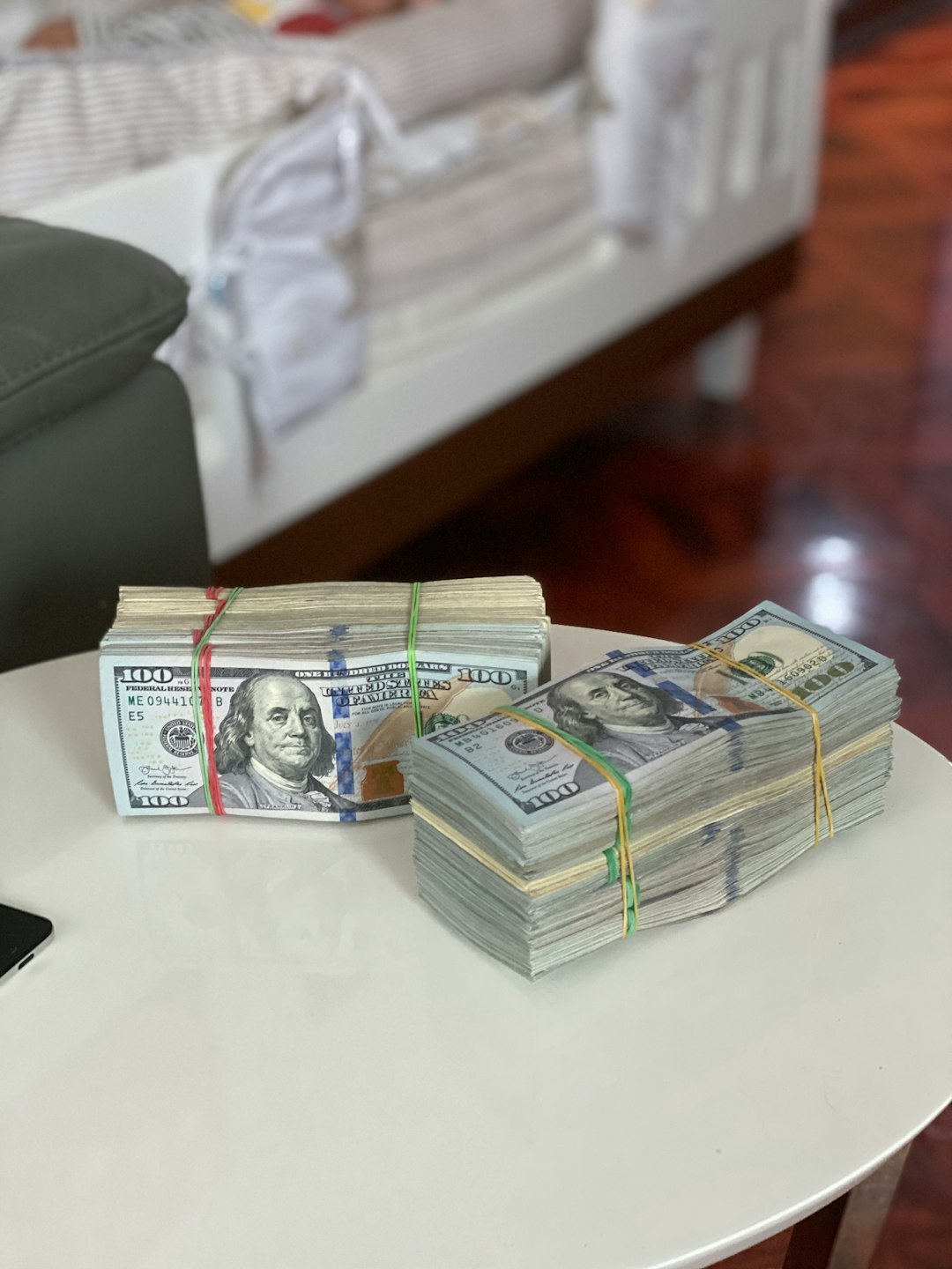 a-stack-of-money-sitting-on-top-of-a-white-table-e-crwdbnl7k